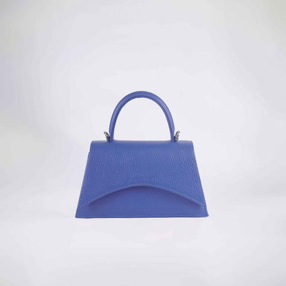 A blue textured handbag with a structured handle and a detachable strap, displayed against a white background.